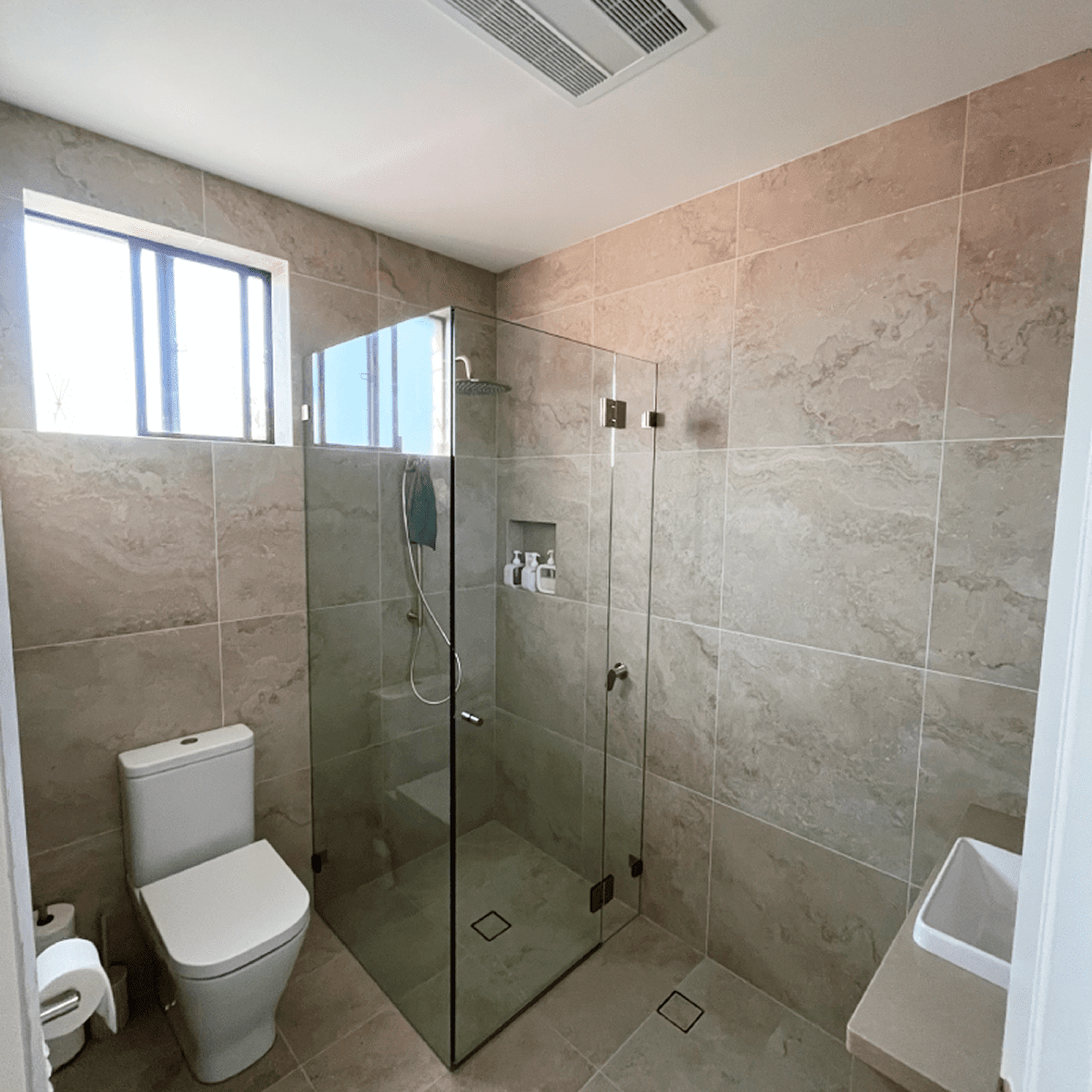 Modern bathroom with glass shower enclosure.