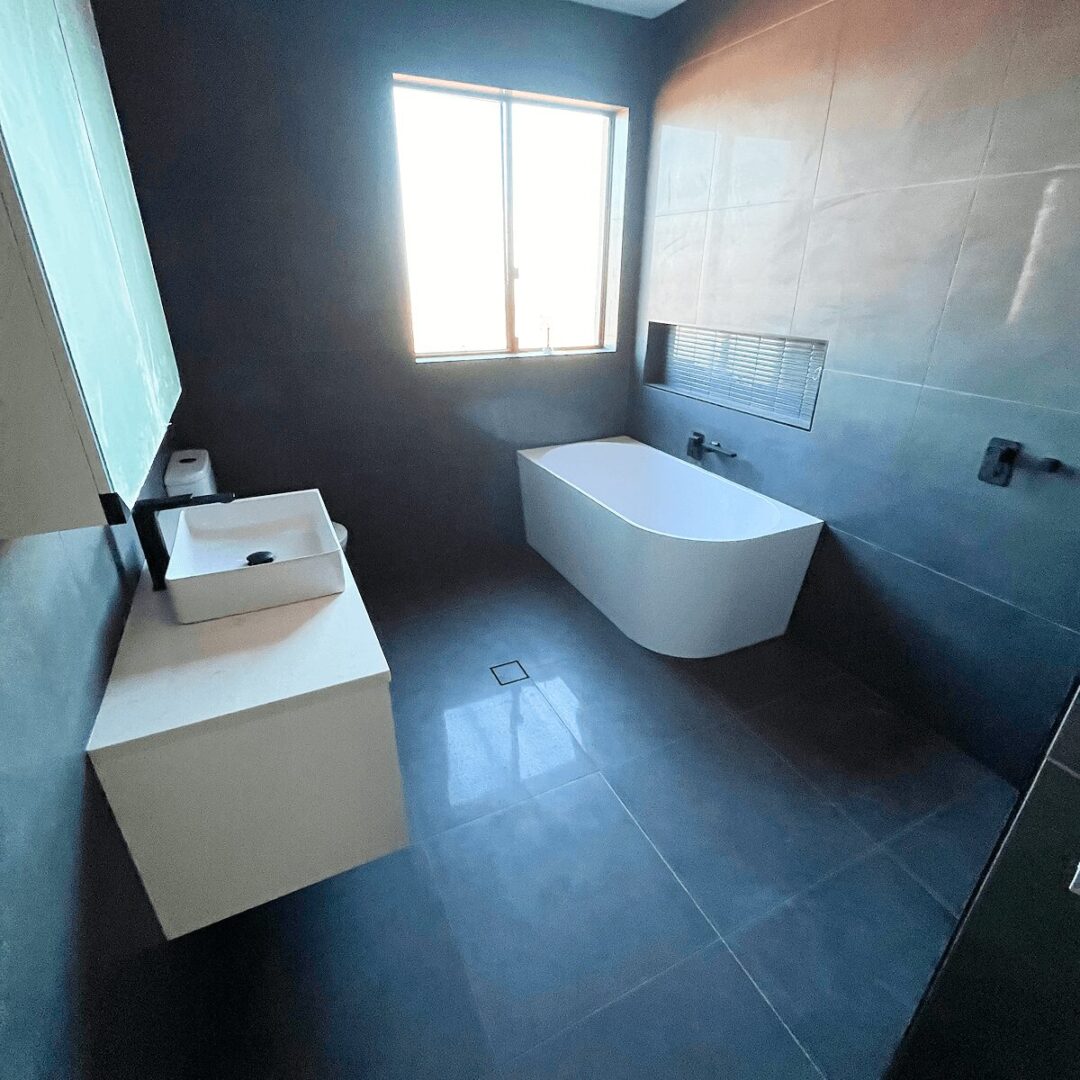 Modern bathroom with bathtub and sink.