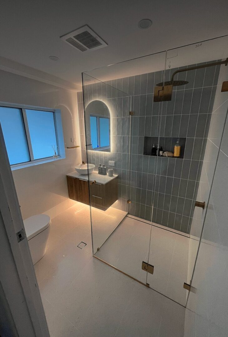 Modern bathroom with glass shower enclosure.